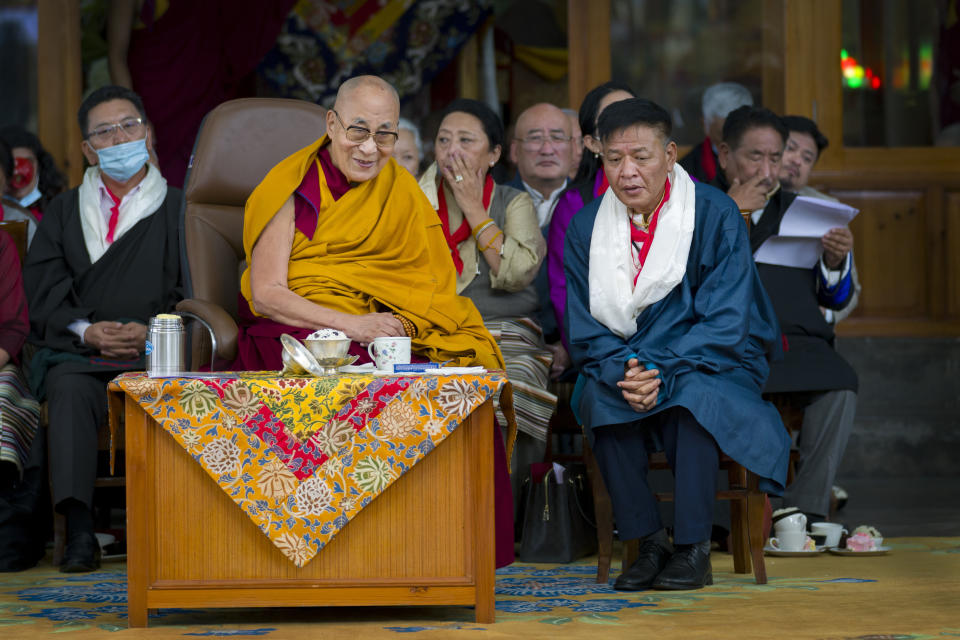 Tibetan spiritual leader the Dalai Lama smiles as he sits next to Penpa Tsering, the president of the Central Tibetan Administration, during a function marking his 88th birthday at the Tsuglakhang temple in Dharamshala, India, Thursday, July 6, 2023. (AP Photo/Ashwini Bhatia)