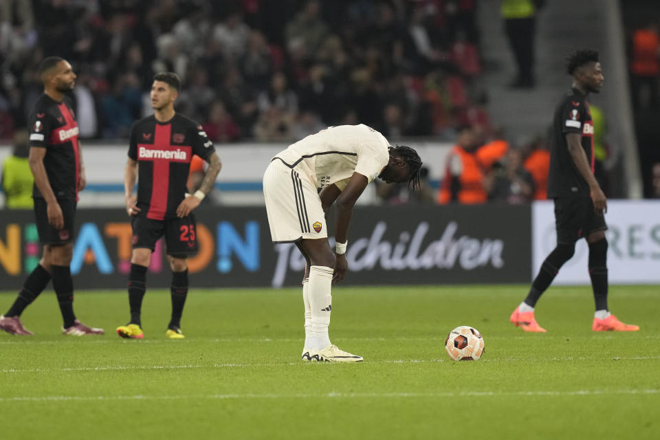 Roma's Tammy Abraham, centre, pauses on the pitch during the Europa League second leg semi-final soccer match between Leverkusen and Roma at the BayArena in Leverkusen, Germany, Thursday, May 9, 2024. (AP Photo/Matthias Schrader)