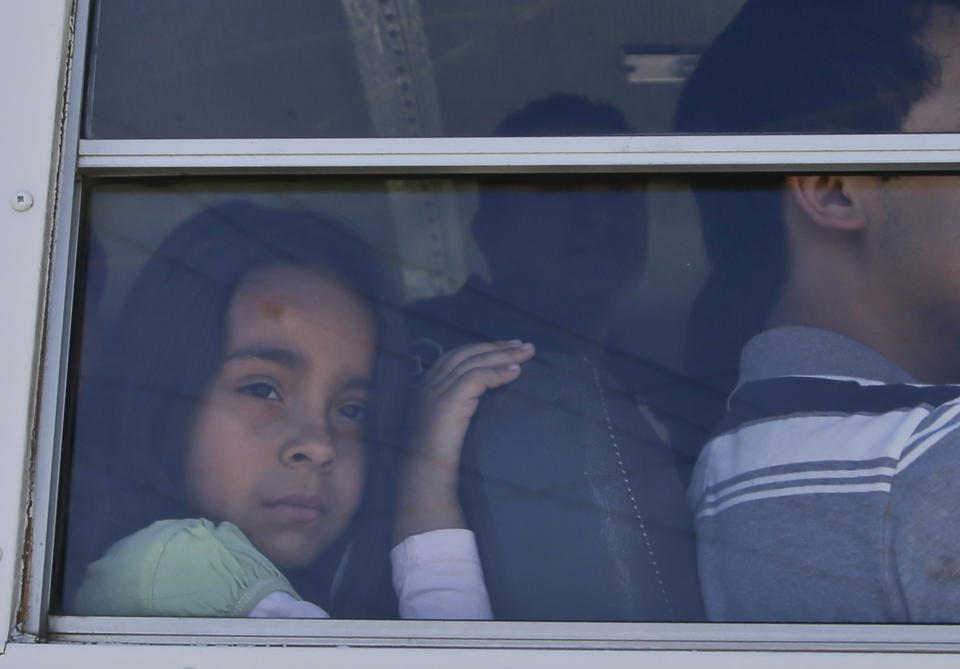A young girl rides in a bus upon its arrival near the United States border for a march of the group Border Dreamers and other supporters of an open border policy Monday, March 10, 2014, in Tijuana, Mexico. (AP Photo/Lenny Ignelzi)