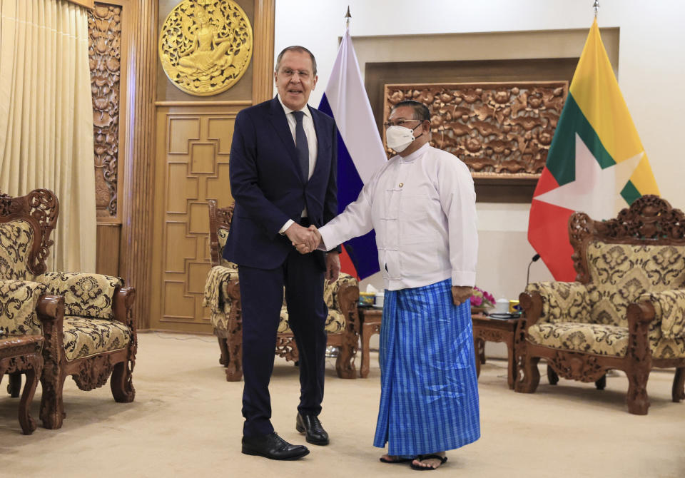 In this handout photo released by the Russian Foreign Ministry Press Service, Myanmar Foreign Minister Wunna Maung Lwin, right, and Russian Foreign Minister Sergey Lavrov shake hands as they pose for a photo prior to their talks in Naypyitaw, Myanmar, Wednesday, Aug. 3, 2022. (Russian Foreign Ministry Press Service via AP)