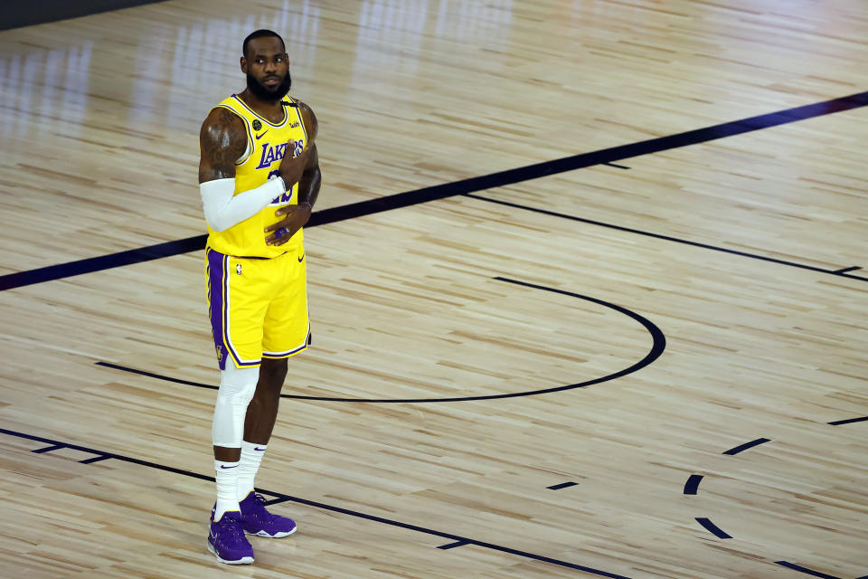 LeBron James stands alone on a basketball court. 