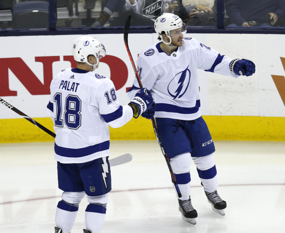 Tampa Bay Lightning defenseman Brayden Point, right, celebrates a goal against the Columbus Blue Jackets with teammate forward Ondrej Palat, of the Czech Republic, during the third period of an NHL hockey game in Columbus, Ohio, Monday, Feb. 18, 2019. Tampa Bay won 5-1. (AP Photo/Paul Vernon)