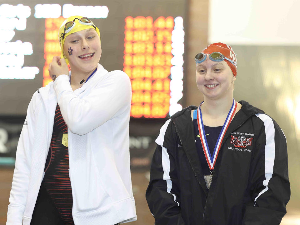 Addie Robillard of St. Ursula, left, finished first in the 100-yard breaststroke at the OHSAA State Swimming and Diving Championships in 2022.
