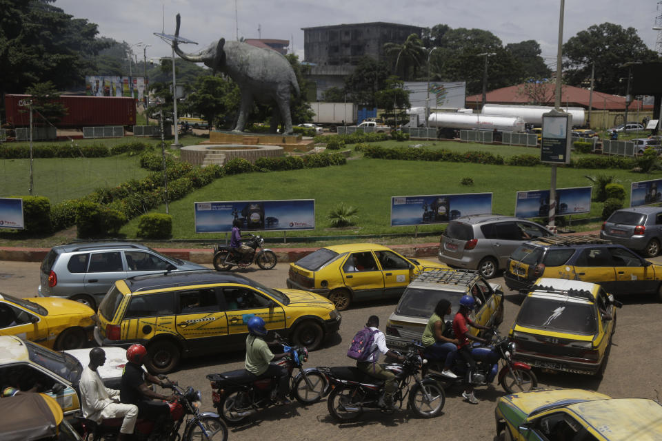 Cars and motorcycle taxi during rush hour on the street in Conakry, Guinea Thursday, Sept. 9, 2021. Guinea's new military leaders sought to tighten their grip on power after overthrowing President Alpha Conde, warning local officials that refusing to appear at a meeting convened Monday would be considered an act of rebellion against the junta. (AP Photo/ Sunday Alamba)