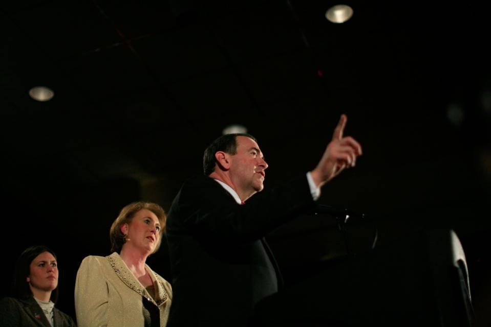 Republican presidential candidate and former Arkansas Gov. Mike Huckabee speaks to supporters as his wife Janet (C) and their daughter Sarah look on during a caucus event on Jan. 3, 2008 in Des Moines, Iowa. Huckabee defeated Gov. Mitt Romney to win the Iowa GOP caucus.