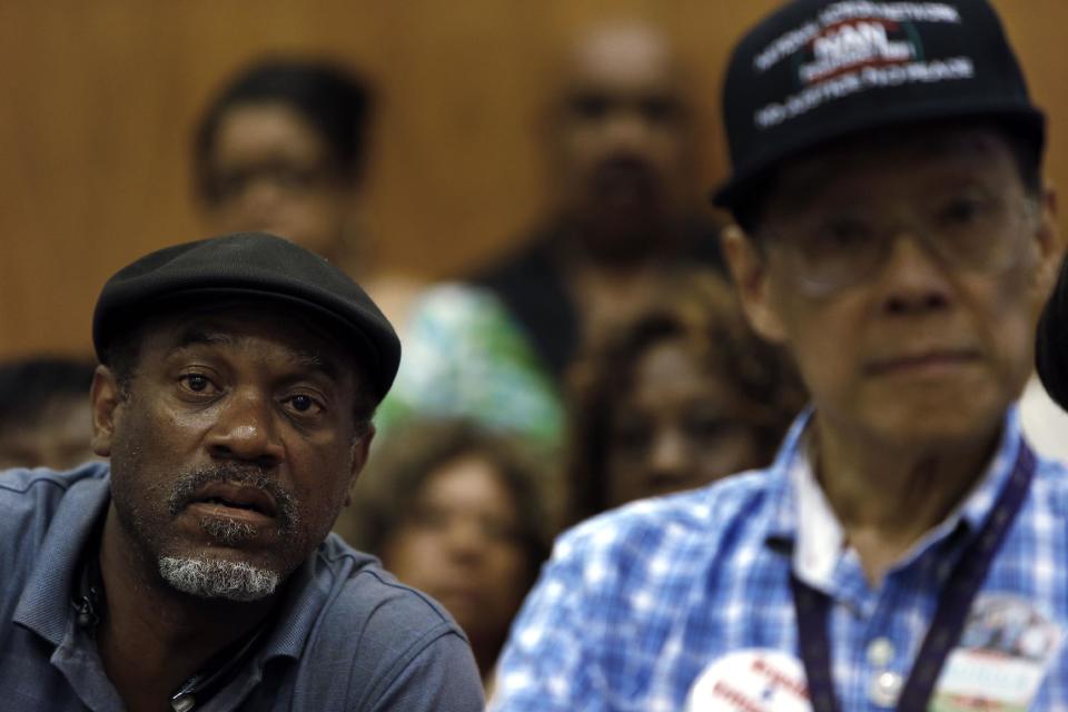 FILE - In this July 22, 2013 file photo Tony Brown, left, a Department of Transportation retiree, listens to union leaders speak in Detroit. Court documents show the city, which now hopes to emerge from bankruptcy, owes more than 100,000 creditors that include individual retirees, city workers, businesses, property owners and litigants. (AP Photo/Paul Sancya)