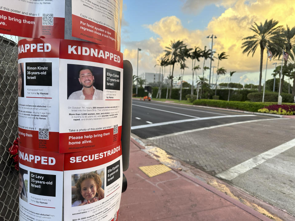 FILE - Flyers with photos of some of the of more than 200 hostages held by Hamas militants after their unprecedented attack on Israel over two weeks ago are displayed to a utility pole, Oct. 24, 2023, in Surfside, Fla. An estimated 525,000 Jews live in Miami's metropolitan area according to the American Jewish Population Project at Brandeis University. In South Florida, rabbis and community leaders are pushing their congregations to call their lawmakers and insist they back Israel as it ramps up its offensive. (AP Photo/Wilfredo Lee, File)