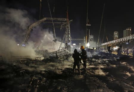 Firefighters try to extinguish a fire at the venue of a cultural event during 'Make in India' week in Mumbai, India, February 14, 2016. REUTERS/Danish Siddiqui