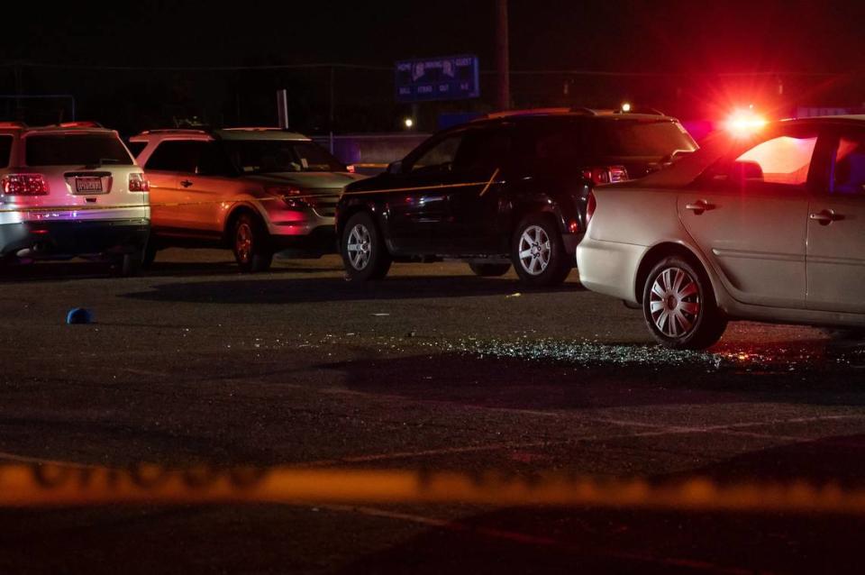 Shattered glass covers the parking lot outside the Grant High School gym after a shooting following the football team’s game against Monterey Trail High School on Friday, Oct. 21, 2022.