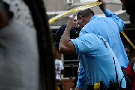 Police officers cross the police line near the scene during an active shooter situation in Philadelphia