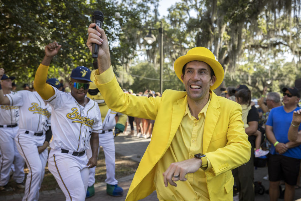 FILE - Savannah Bananas owner Jesse Cole emcees a pregame parade and performance for the fans before the gates opened Tuesday, June 7, 2022, in Savannah, Ga. The Savannah Bananas, who became a national sensation with their irreverent style of baseball, are leaving the Coastal Plains League to focus full attention on their professional barnstorming team. Owner Jesse Cole made the announcement in a YouTube video, saying “we'll be able to bring the Savannah Bananas to more people in Savannah and around the world."(AP Photo/Stephen B. Morton, File)