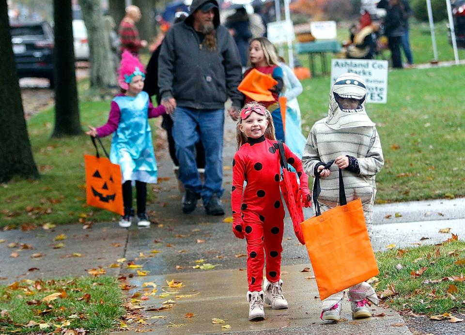 Lilli Ramsey and Jordynn Adkins walk along Morgan Avenue during the city of Ashland’s trick or treat in October 2020.