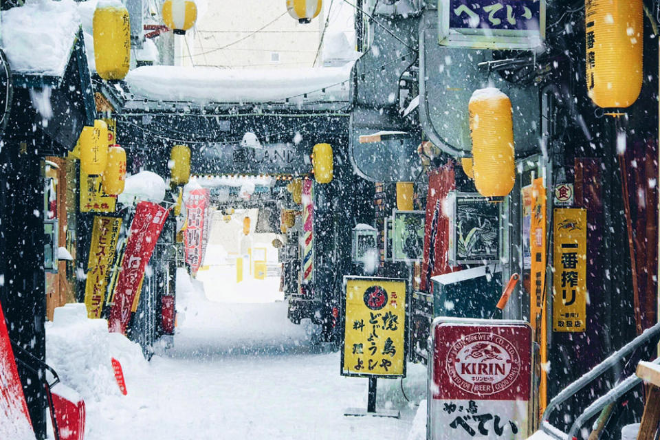 Yellow 'chochin' lanterns beckon customers to enter 'izakayas' along a snow-laden alley in Hokkaido. — Pictures by CK Lim