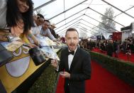 Actor Aaron Paul, from the drama series "Breaking Bad," signs an autograph as he arrives at the 20th annual Screen Actors Guild Awards in Los Angeles, California January 18, 2014. REUTERS/Mario Anzuoni (UNITED STATES - Tags: ENTERTAINMENT) (SAGAWARDS-ARRIVALS)