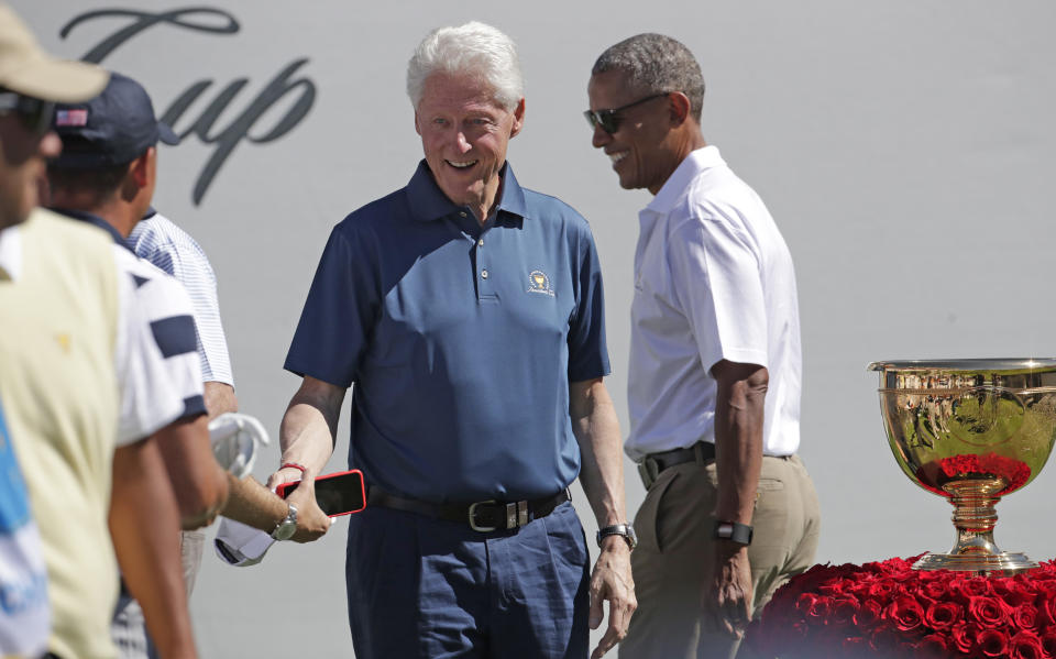 <p>Former Presidents Barack Obama, right, and Bill Clinton greet U.S. team members before the first round of the Presidents Cup at Liberty National Golf Club in Jersey City, N.J., Thursday, Sept. 28, 2017. (AP Photo/Julio Cortez) </p>