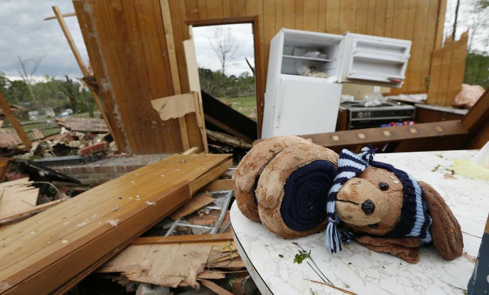 A stuffed puppy dog lay across a kitchen table in this storm damaged home in Morton, Miss., Friday, April 19, 2019. With no roof, all that remained of his house were a few walls, as its contents were spread across several lots after being hit by a possible tornado, Thursday afternoon. Strong storms again roared across the South on Thursday, topping trees and leaving a variety of damage in Mississippi, Louisiana and Texas. (AP Photo/Rogelio V. Solis)