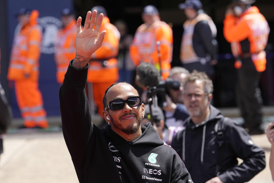 Mercedes driver Lewis Hamilton of Britain waves to spectators during a driver's parade ahead the British Formula One Grand Prix at the Silverstone racetrack, Silverstone, England, Sunday, July 7, 2024. AP Photo/Luca Bruno)