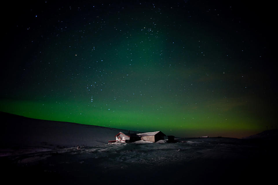 Merit Winner: A lonely cabin is illuminated under the Northern Lights in Finmmark, Norway. (Photo and caption by Michelle Schantz/National Geographic Traveler Photo Contest) <br> <br> <a href="http://travel.nationalgeographic.com/travel/traveler-magazine/photo-contest/2012/entries/gallery/winners/" rel="nofollow noopener" target="_blank" data-ylk="slk:Click here to see the National Geographic Traveler's Winners Gallery;elm:context_link;itc:0;sec:content-canvas" class="link ">Click here to see the National Geographic Traveler's Winners Gallery</a>