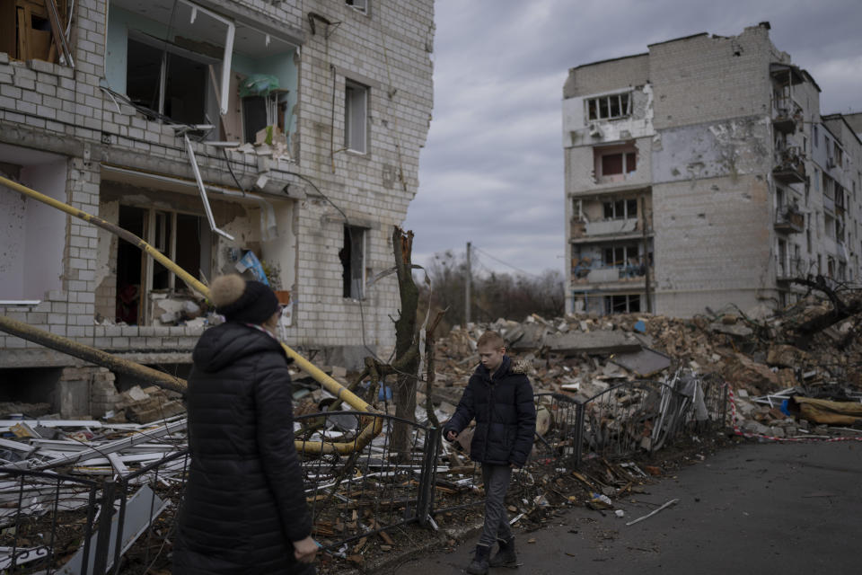 A boy is searching for his cat as he walks outside a destroyed apartment building in the town of Borodyanka, Ukraine, on Saturday, April 9, 2022. Russian troops occupied the town of Borodyanka for weeks. Several apartment buildings were destroyed during fighting between the Russian troops and the Ukrainian forces in the town around 40 miles northwest of Kiev. (AP Photo/Petros Giannakouris)