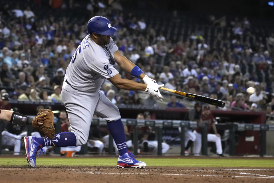 Los Angeles Dodgers' Albert Pujols hits a three-run double against the Arizona Diamondbacks in the second inning during a baseball game, Sunday, Aug 1, 2021, in Phoenix. (AP Photo/Rick Scuteri)