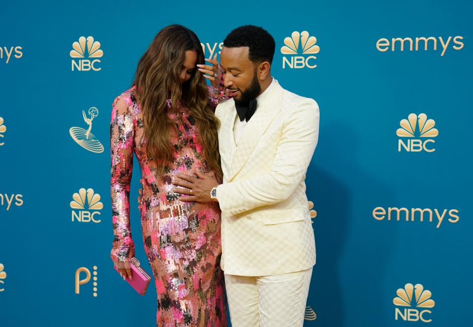 A pregnant Chrissy Teigen, left, and John Legend arrive at the 74th Emmy Awards on Monday. Legend performed his new song, "Pieces," during the show's In Memoriam segment.