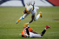Los Angeles Chargers strong safety Rayshawn Jenkins, top, is tackled by Denver Broncos wide receiver K.J. Hamler (13) after Jenkins intercepted a pass during the second half of an NFL football game, Sunday, Nov. 1, 2020, in Denver. (AP Photo/David Zalubowski)