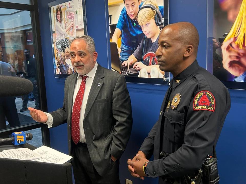 Wake County school board chair Chris Heagarty and Raleigh Deputy Police Chief Rico Boyce speak at a news conference about a gun safety storage resolution in Cary, N.C., on March 19, 2024