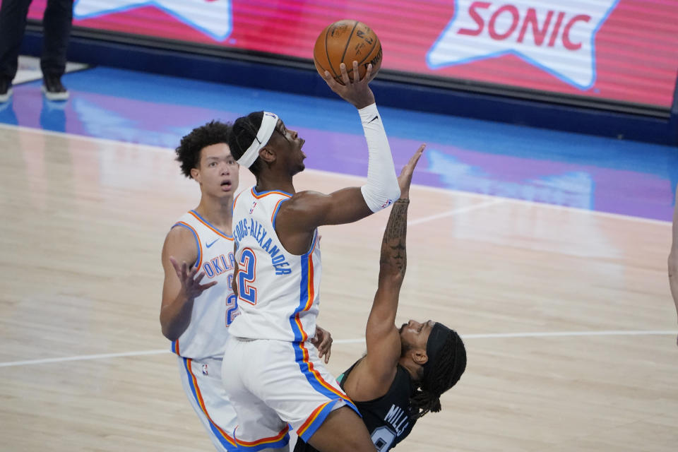 Oklahoma City Thunder guard Shai Gilgeous-Alexander (2) shoots over San Antonio Spurs guard Patty Mills, right, during the second half of an NBA basketball game Wednesday, Feb. 24, 2021, in Oklahoma City. (AP Photo/Sue Ogrocki)