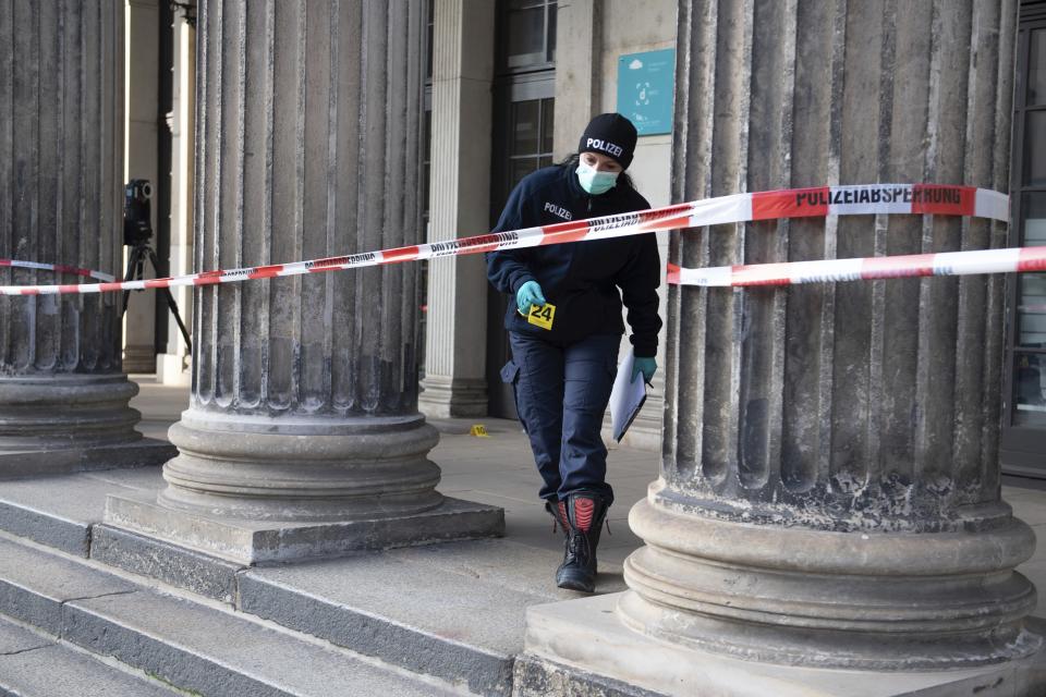 An police officer walks behind a caution tape at the Schinkelwache building in Dresden Monday, Nov. 25, 2019. Authorities in Germany say thieves have carried out a brazen heist at Dresden’s Green Vault, one of the world’s oldest museum containing priceless treasures from around the world. (Sebastian Kahnert/dpa via AP)