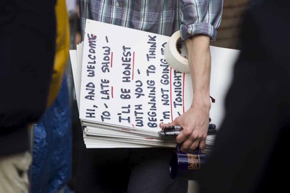 A man carries a cue card for David letterman outside the Ed Sullivan Theater in Manhattan after the taping of tonight's final edition of "The Late Show" with David Letterman in New York