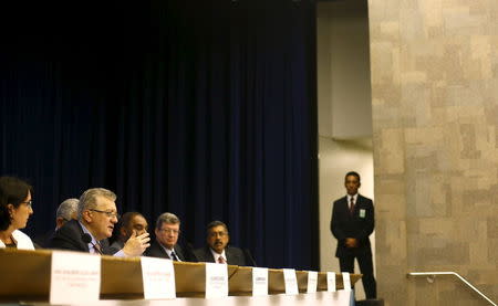 Petroleo Brasileiro SA President Aldemir Bendine (L) and his board present the company's 2014 results in Rio de Janeiro April 22, 2015. REUTERS/Ricardo Moraes