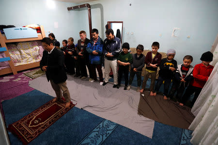 Uighur men and boys perform their evening prayers led by Ruz Mohammed, known as Hafiz Bilal, in a madrasa, or religious school, in Kayseri, Turkey, January 31, 2019. REUTERS/Murad Sezer