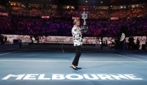 Former Australian Open champion Margaret Court holds up the women's Australian Open trophy, the Daphne Ackhurst Memorial Cup, as her 50th anniversary of her Grand Slam is celebrated at the Australian Open tennis championship in Melbourne, Australia, Monday, Jan. 27, 2020. (AP Photo/Lee Jin-man)