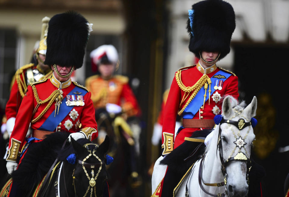 Prince Charles pictured with Prince William, both on horseback, during the ceremony.