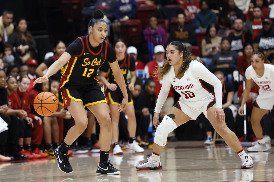 Southern California guard JuJu Watkins (12) brings the ball up court against Stanford guard Talana Lepolo (10) in the second half of an NCAA college basketball game on Friday, Feb. 2, 2024 in Stanford, Calif. (AP Photo/Josie Lepe)