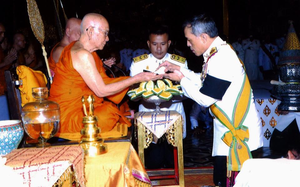 The king, shown here paying respect to the new Supreme Patriarch Somdej Phra Maha Muniwong, was allegedly targeted by plastic bullets - Credit: EPA/ROYAL HOUSEHOLD BUREAU