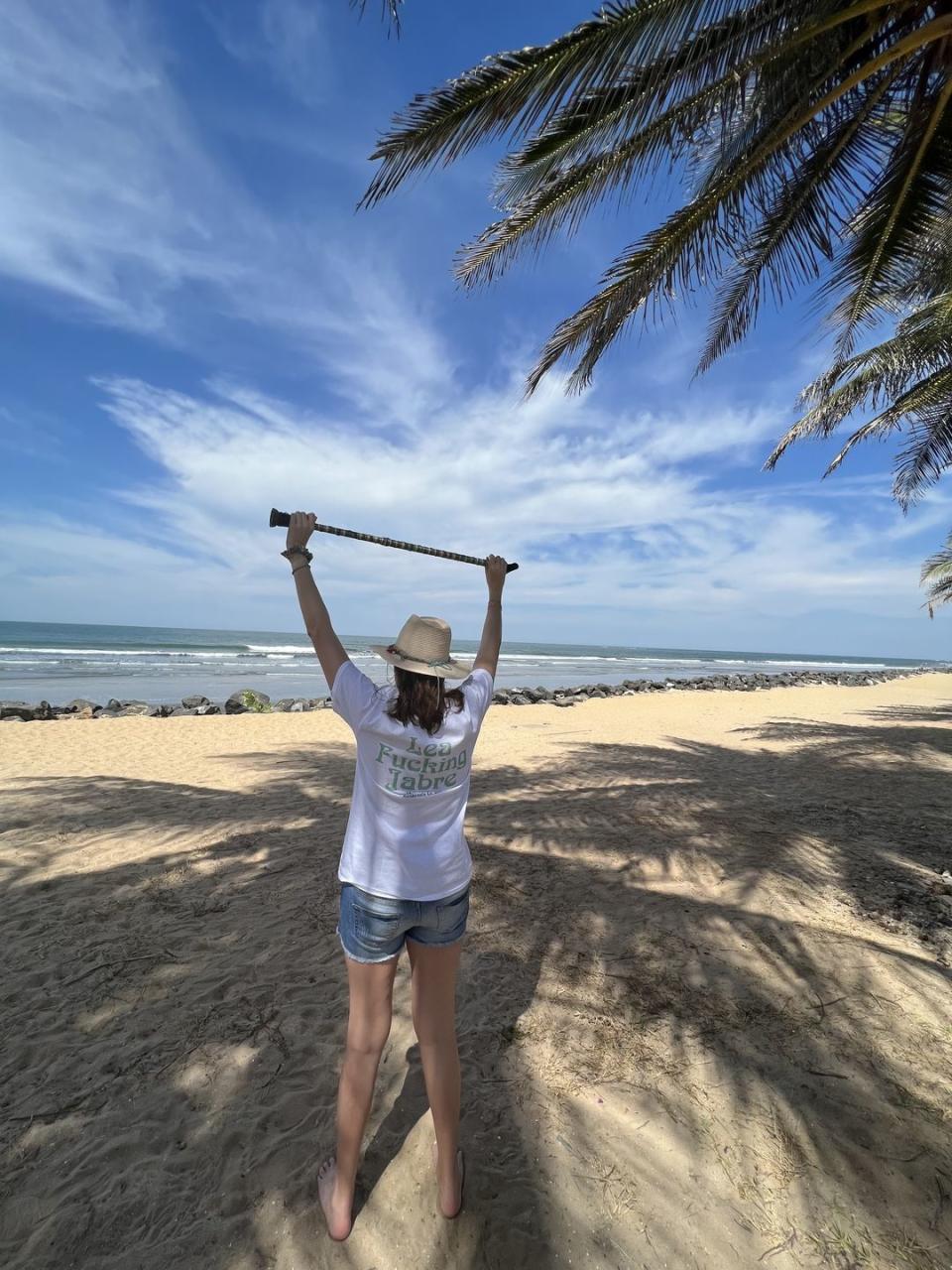 lea jabre on the beach wearing a lea fucking jabre t shirt