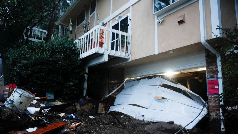 A garage door is damaged by a storm on a home on Monday in Studio City. - Marcio Jose Sanchez/AP