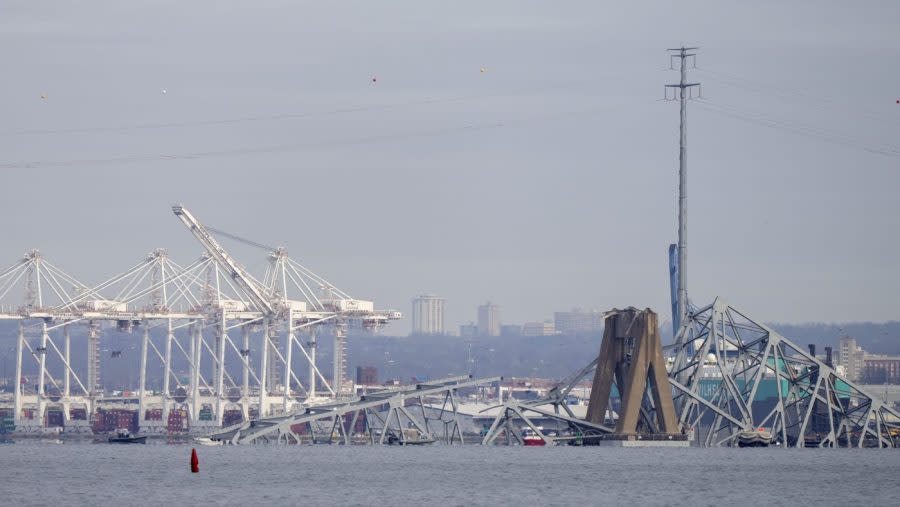 The wreckage of the Francis Scott Key Bridge sits in the water on Tuesday, March 26, 2024, as seen from Pasadena, Md. A container ship rammed into a major bridge in Baltimore early Tuesday, causing it to collapse in a matter of seconds and creating a terrifying scene as several vehicles plunged into the chilly river below. (AP Photo/Mark Schiefelbein)