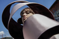 A young model wears a creation by fashion student Nora Bourelly on a street outside Valentino women's Spring-Summer 2021 fashion show location, in Milan, Italy, Sunday, Sept. 27, 2020. (AP Photo/Luca Bruno).