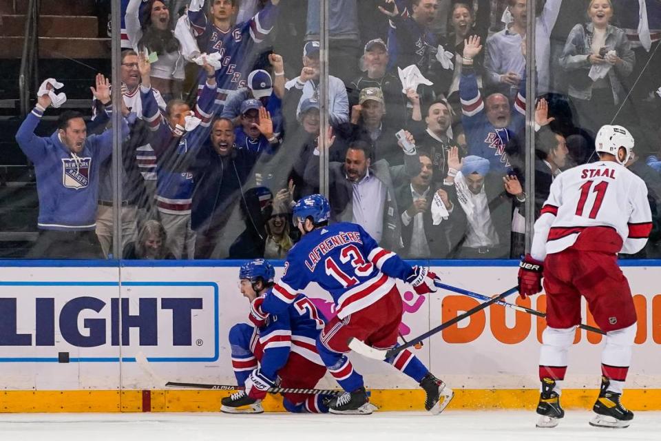 New York Rangers center Frank Vatrano (77) celebrates after scoring on Carolina Hurricanes goaltender Antti Raanta in the first period of Game 4 of an NHL hockey Stanley Cup second-round playoff series, Tuesday, May 24, 2022, in New York. (AP Photo/John Minchillo)