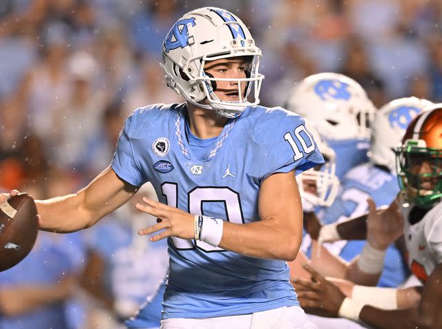 <p>Grant Halverson/Getty</p> Drake Maye drops back to pass against the Florida A&M Rattlers during their game on August 27, 2022 in Chapel Hill, North Carolina.