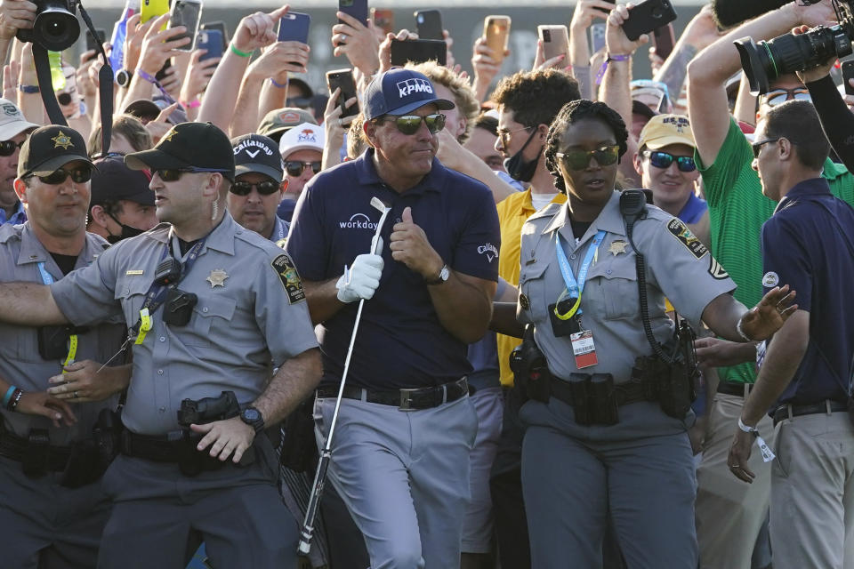 Phil Mickelson makes his way through fans on the 18th fairway during the final round at the PGA Championship golf tournament on the Ocean Course, Sunday, May 23, 2021, in Kiawah Island, S.C. (AP Photo/Matt York)