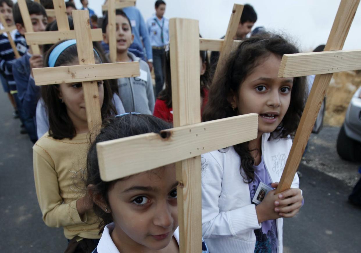 <span class="caption">A procession of Christian girls, venerating the Cross, in the village of Qanat Bekish, Lebanon.</span> <span class="attribution"><a class="link " href="http://www.apimages.com/metadata/Index/Mideast-Lebanon-Cross/161bf78b0fd54388a1ebb7ce7f3a9e3d/30/0" rel="nofollow noopener" target="_blank" data-ylk="slk:AP Photo/Hussein Malla;elm:context_link;itc:0;sec:content-canvas">AP Photo/Hussein Malla</a></span>