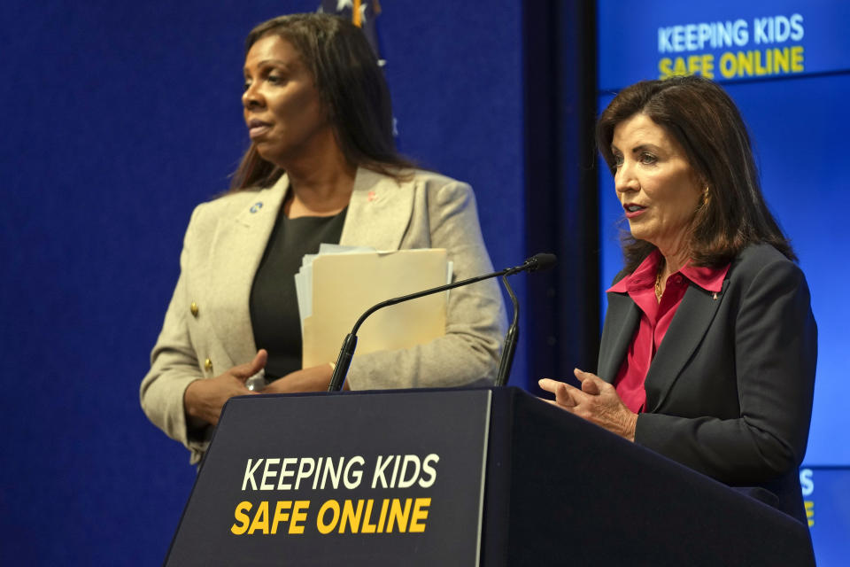 New York Gov. Kathy Hochul, right, speaks as Attorney General Letitia James listens during a news conference in New York, Wednesday, Oct. 11, 2023. New York is bidding to put new controls on social media platforms that state leaders say will protect the mental health of younger users. (AP Photo/Seth Wenig)