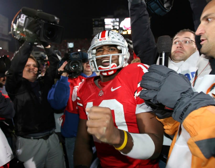 FILE – Ohio State quarterback Troy Smith celebrates in Columbus, Ohio after Ohio State beat Michigan, 42-39 in Columbus, Ohio, Nov. 18, 2006. (AP Photo/Terry Gilliam, File)