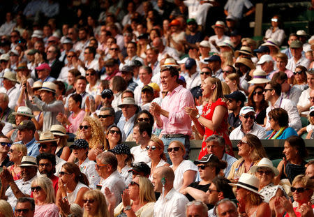 Tennis - Wimbledon - All England Lawn Tennis and Croquet Club, London, Britain - July 13, 2018. fans cheer as John Isner of the U.S. plays his semi final match against South Africa's Kevin Anderson after the match becomes the longest played on Centre Court, and the second longest in tournament's history. REUTERS/Andrew Boyers