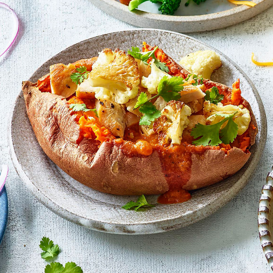 <p>Use convenience ingredients, like cooked chicken (leftover or purchased) and store-bought curry sauce to whip up these easy loaded baked potatoes. We call for cauliflower in this recipe, but feel free to sub in whatever veggies you have on hand for a quick and easy dinner. You can also swap the sweet potatoes for russets. <a href="https://www.eatingwell.com/recipe/275785/chicken-curry-stuffed-sweet-potatoes/" rel="nofollow noopener" target="_blank" data-ylk="slk:View Recipe;elm:context_link;itc:0;sec:content-canvas" class="link ">View Recipe</a></p>