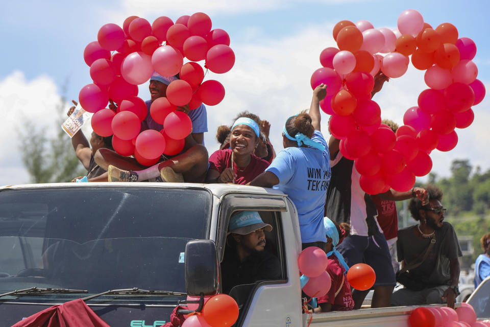 Locals react as they participate in a candidates parade in the capital Honiara, Solomon Islands, Monday, April 15, 2024. The country in which China has gained most influence in the South Pacific, Solomon Islands, goes to the polls on Wednesday in an election that could shape the region's future. (AP Photo/Charley Priringi)