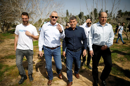 FILE PHOTO: Benny Gantz, head of the Blue and White party, walks with fellow party candidates during a visit to a kibbutz in Israel outside the northern Gaza Strip, March 13, 2019. REUTERS/Amir Cohen/File Photo